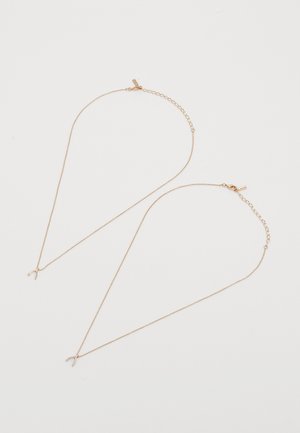 Guldfarvet kæde med et ønskeknogle vedhæng, med et delikat design og justerbar længde for tilpasset pasform.