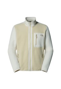 Fleecejakke i krem og lys beige med høy krage, full-zip front, sidelommer med glidelås og en liten brystlomme. Myk tekstur.