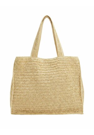 Bolso tote tejido beige con dos asas anchas, forma rectangular y un patrón texturizado de tejido abierto.