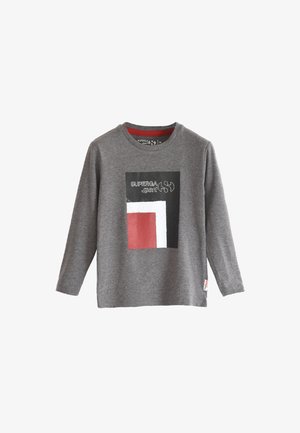 Long-sleeve gray t-shirt made of cotton, featuring a front graphic in black, white, and red with "SUPERGA" text. Round neckline, tag on side.