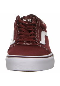 Red canvas skate shoes with white accents, lace-up front, and a padded collar. Features a textured rubber sole and contrasting stitching.