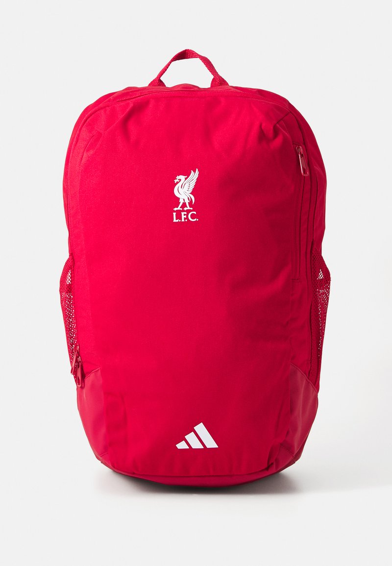Red backpack made of fabric, featuring a Liverpool FC logo in white, a side mesh pocket, and a bottom accent with three white stripes.