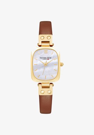 Montre rectangulaire dorée avec cadran blanc, index dorés, bracelet en cuir marron et logo "Victoria Hyde London" sur le cadran.