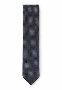 Cravatta blu con pois bianchi. Realizzata in tessuto morbido, presenta una classica forma stretta e punta appuntita, adatta per occasioni formali.