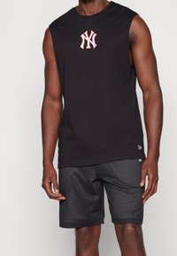 Black sleeveless shirt with embroidered red NY logo, paired with black mesh shorts featuring small perforations and a smooth waistband.