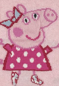 Knitted pink fabric depicting a cartoon pig character with a light blue bow, wearing a pink polka-dot dress and red shoes.