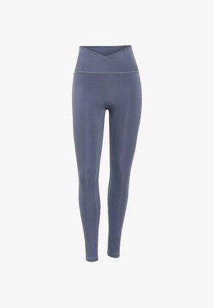 Legginsy w głębokim odcieniu szarości, z wysokim, zakładanym pasem oraz gładkim, elastycznym materiałem z minimalnymi przeszyciami.