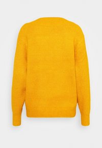 Pull jaune en maille avec texture côtelée, présentant des manches longues et un col rond. Vue de dos montrant un design sans coutures et une coupe décontractée.