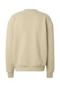 Sudadera beige de manga larga con puños y dobladillo acanalados, patrón diagonal texturizado, vista desde atrás.