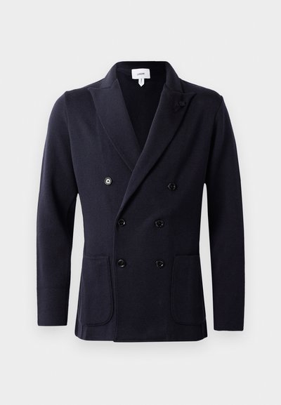 Navy double-breasted jacket made from textured fabric, featuring six black buttons and two front pockets. Shawl collar design.