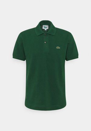 Polo vert foncé à manches courtes avec col côtelé, patte à deux boutons et petit logo crocodile vert sur la poitrine gauche.