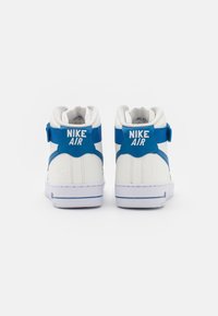 Witte hoge sneakers met blauwe accenten, gemaakt van geborsteld leer, met een gewatteerde kraag en het "Nike Air"-logo op de achterkant.