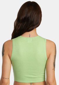 Light green cropped tank top with a ribbed texture. Features a round neckline and wide shoulder straps. No visible hardware or patterns.