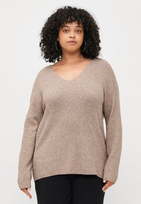 Light brown, ribbed knit sweater with a wide V-neckline and dropped shoulders. Long sleeves and a relaxed fit with side slits at the hem.