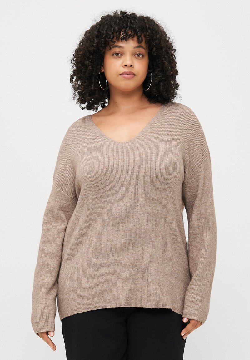 Light brown, ribbed knit sweater with a wide V-neckline and dropped shoulders. Long sleeves and a relaxed fit with side slits at the hem.