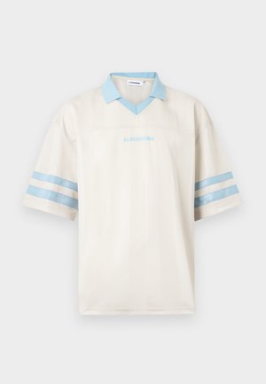 Short-sleeve white polo shirt with light blue collar, two blue stripes on each sleeve, and light blue "J.LINDEBERG" text on front.