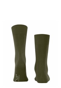 Calzini in cotone verde oliva con texture a costine e finitura liscia; altezza alla caviglia con dettaglio di branding sottile vicino all'unghia.