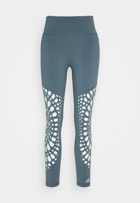 Leggings atletici blu con vita alta, caratterizzati da un motivo geometrico bianco sulla parte inferiore della gamba e una texture liscia e elastica.
