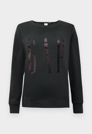 Svart crewneck sweatshirt laget av bomullsblanding, med en glanset "GAP"-logo foran. Lange ermer og ribbestrikkede mansjetter.