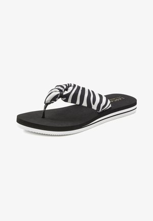 Black and white striped flip-flop with a knotted fabric strap, textured black sole, and white accents on the bottom edge.
