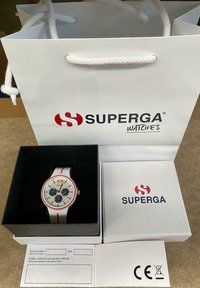 White watch with silver dial, red accents, and blue subdials. Presented in a black box with a white paper bag labeled "SUPERGA."