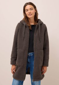 Veste en polaire grise avec capuche, fermeture éclair et deux poches avant. Matériau texturé avec une apparence confortable. Coupe décontractée, mi-longue.