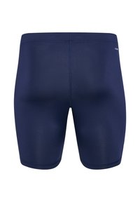 Mörkblå simshorts tillverkade av elastiskt material, med en åtsittande design, platta sömmar och en mjuk textur. Inga synliga mönster eller logotyper.