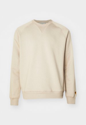 Beige sweatshirt in soft cotton blend, featuring ribbed cuffs and hem, raglan sleeves, and a small metal logo accent on the left sleeve.