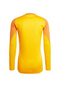 Maglietta sportiva a maniche lunghe di un brillante giallo con maniche arancioni a contrasto, realizzata in tessuto morbido e elasticizzato. Presenta un collo rotondo e un logo.