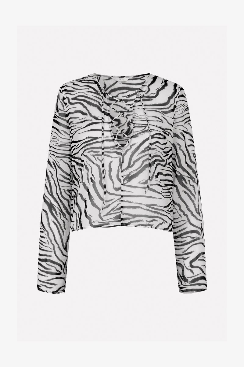Haut cropped noir et blanc transparent avec un motif zèbre, présentant des manches longues et un décolleté lacé.