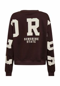 Sweat-shirt marron avec de grandes lettres blanches "DR" et "SUNSHINE STATE" au dos. Comprend un col et des poignets côtelés.