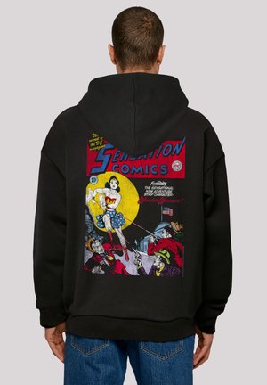 Black hooded sweatshirt featuring a vintage comic cover illustration on the back, depicting Wonder Woman in vibrant colors and bold graphics.