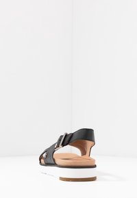 UGG Sandaalit nilkkaremmillä - black