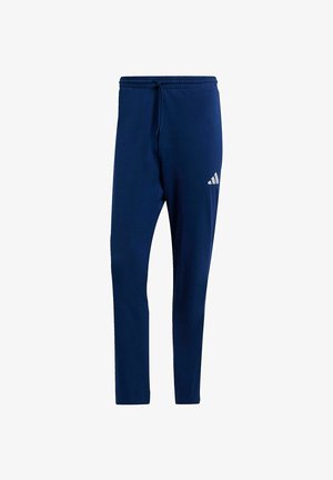 Pantalon de sport bleu marine avec taille élastique et cordon de serrage, affichant un petit logo Adidas blanc sur la cuisse supérieure.