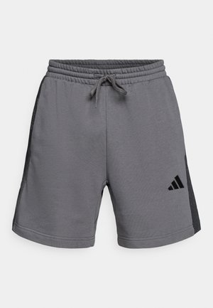 Gray athletic shorts with side mesh panels, elastic waistband, adjustable drawstring, and Adidas logo in black on the lower left leg.