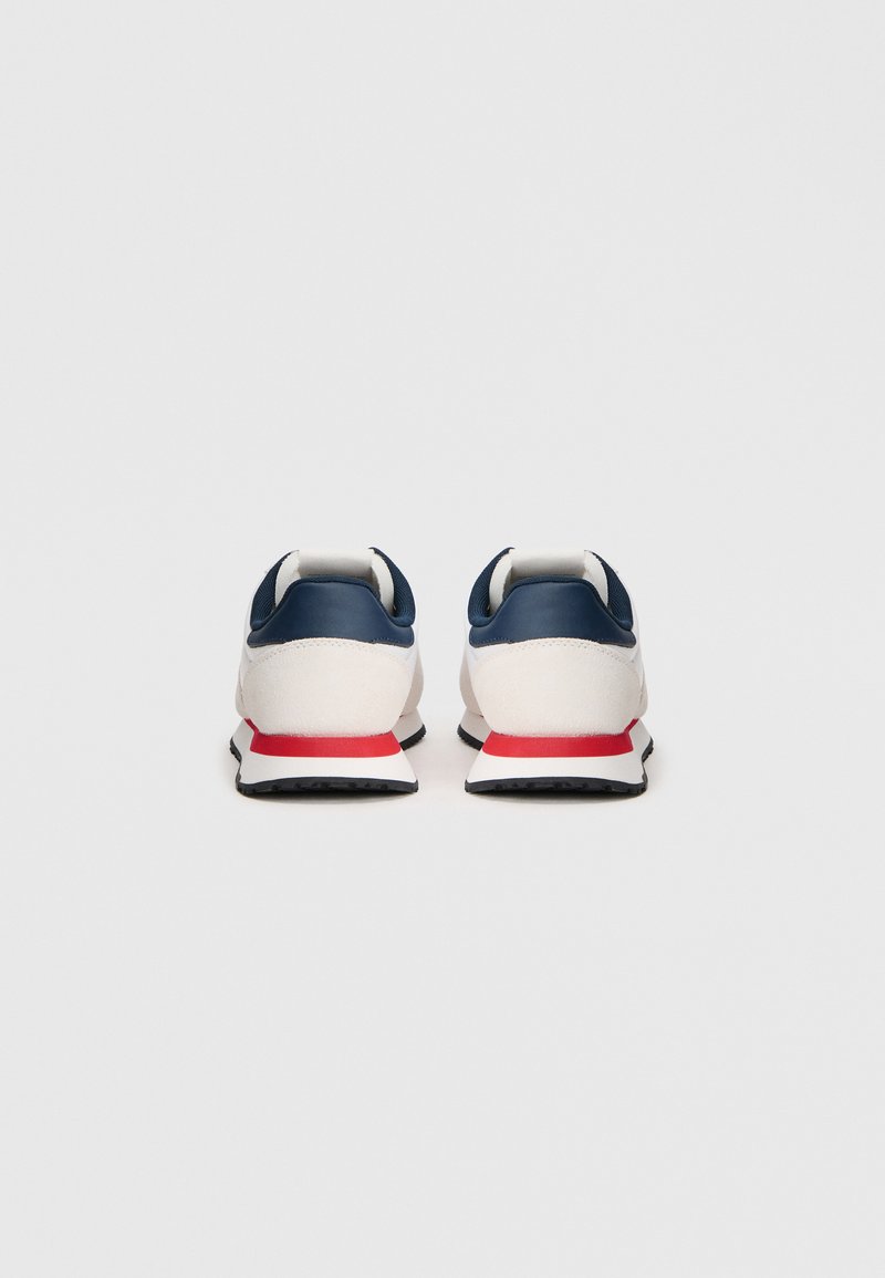 Pair of white sneakers with navy blue heel collars and red stripes on white midsoles, viewed from the back on a plain background.