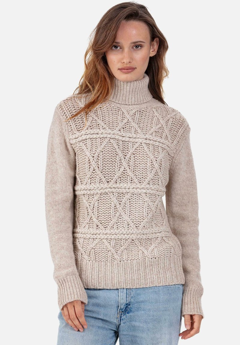 Pull beige en tricot avec un col montant, présentant des motifs texturés en diamants et des poignets côtelés. Matière en laine douce avec une coupe décontractée.
