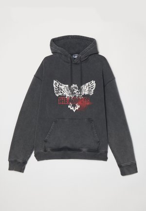 Black, oversized hoodie with a graphic print featuring an eagle and the text "THE KINGS." Includes a front pocket and drawstring hood.