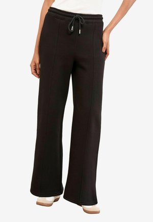 Schwarze Sweatpants aus weichem Material, mit lockerer Passform, weitem Bein und elastischem Bund mit Kordelzug und silbernen Akzenten.