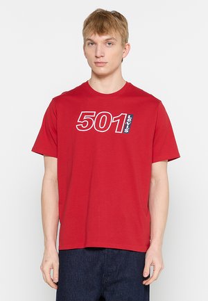 Red cotton short-sleeve t-shirt featuring white "501" and "Levi's" text design on the front, round neckline, and standard fit.