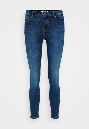 Jeans skinny fit in denim blu scuro. Presentano cinque tasche, una chiusura con bottone e un leggero sbiadimento lungo cosce e ginocchia.