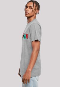 Gray cotton t-shirt featuring a graphic design in red and teal hues, with a relaxed fit and crew neckline.