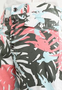 Blommönstrade byxor med stora gröna, rosa och blå blad. Tillverkade av bomull med knäppning i gylfen och framfickor.