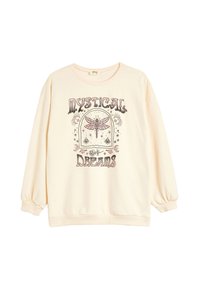 Sudadera color crema con mangas largas abullonadas. Presenta una impresión gráfica de una libélula y el texto "Sueños Místicos" en negro y rosa.