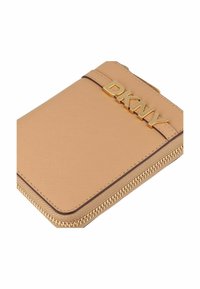 DKNY wallet in beige textured material with gold zip closure and logo. Features a slim design and rounded corners.