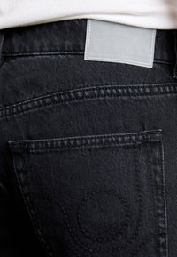 EYTYS CYRUS RAVEN - Flared Jeans - black