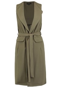 Vestido sin mangas de color verde oliva con cuello de chal, cintura ceñida con cinturón y dos bolsillos frontales. Hecho de tejido suave, ajuste entallado.