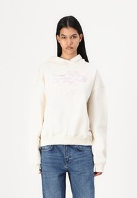 Cream-colored hooded sweatshirt with a loose fit, featuring a graphic design in pink and blue on the front, ribbed cuffs, and hem.