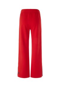 Red wide-leg pants made of soft cotton. Features an elastic waistband and side slits, providing a relaxed fit. No visible patterns or accents.