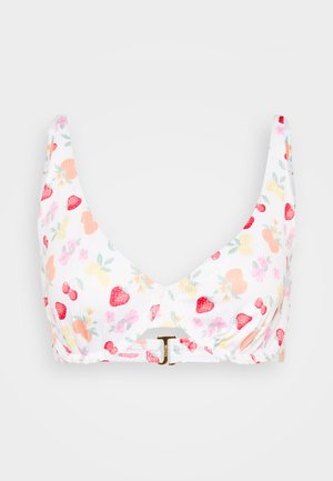White bikini top featuring a ribbed texture with a multicolored fruit and floral pattern; front twist design with a gold buckle accent.